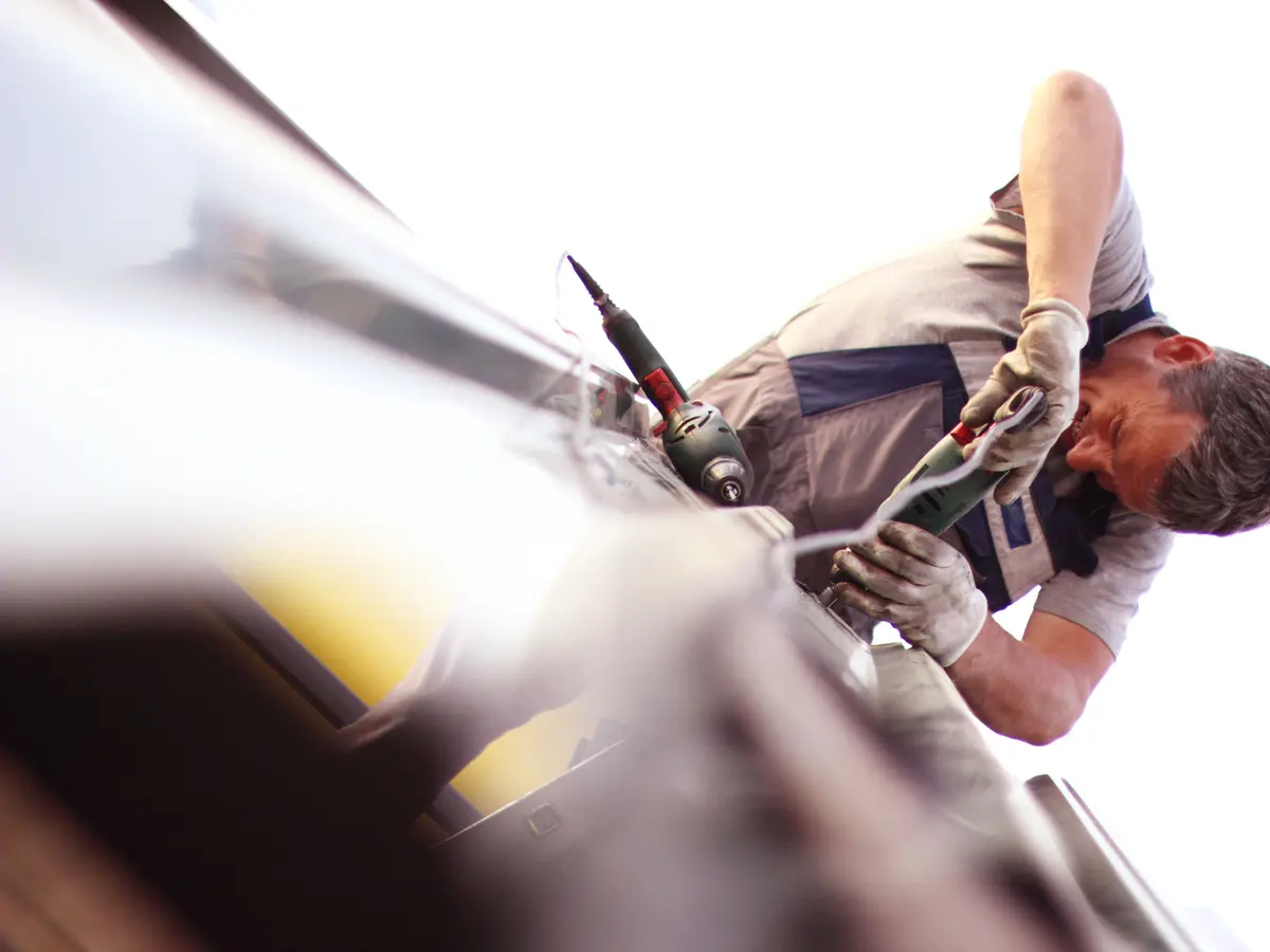 Roofer fixing guttering at the roof edge