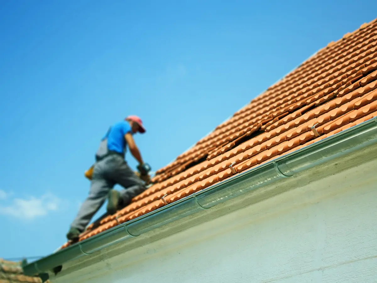 Roofer working on a clay tiled roof