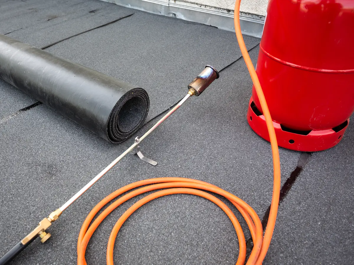 New torch-on felt being laid on a flat roof