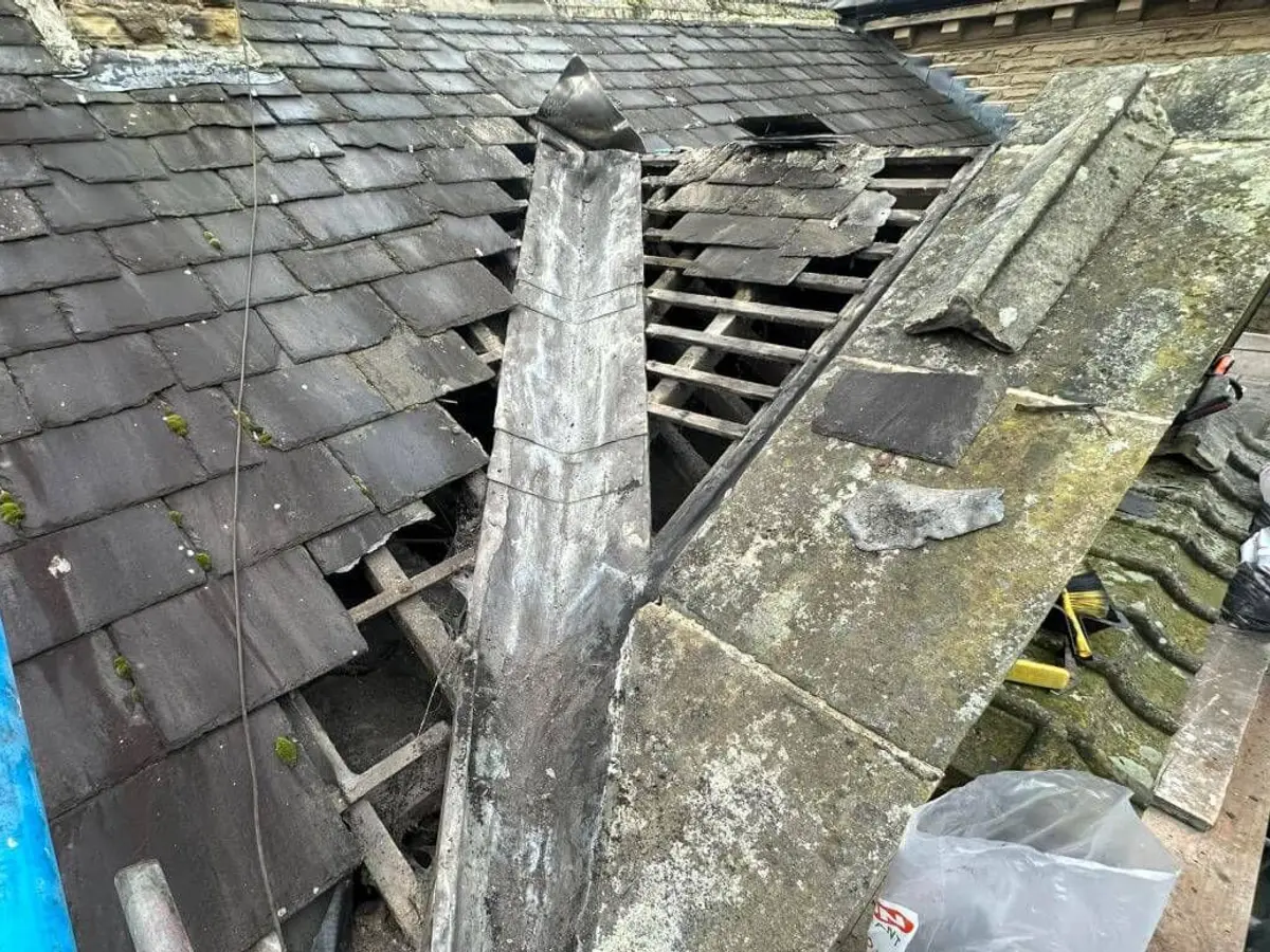 Damaged slate roof opened up for repair