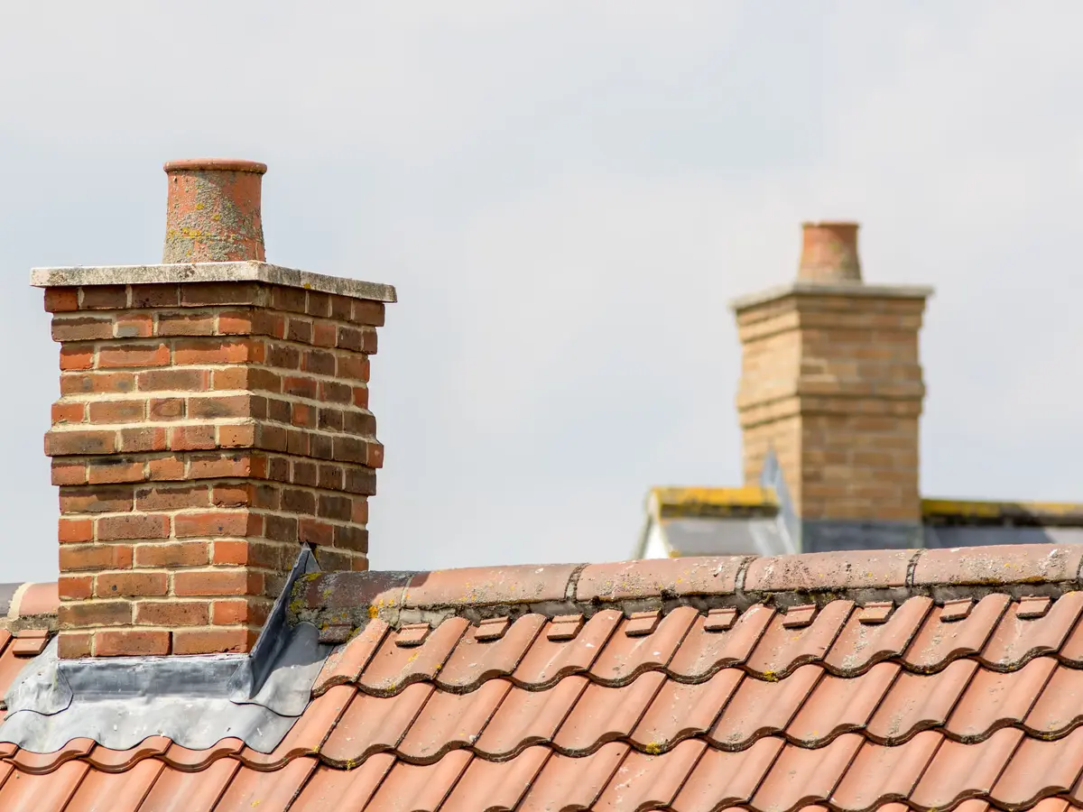 Brick chimney stacks on a clay tiled roof