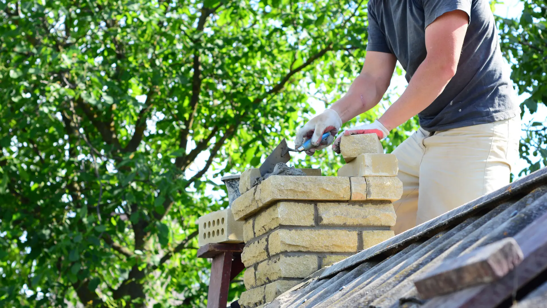 Chimney stack being rebuilt on a house roof