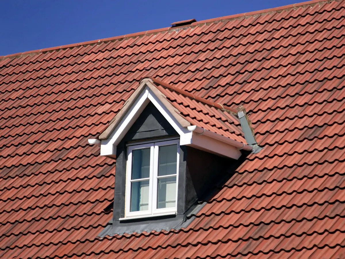 Red clay tiled roof with a dormer window