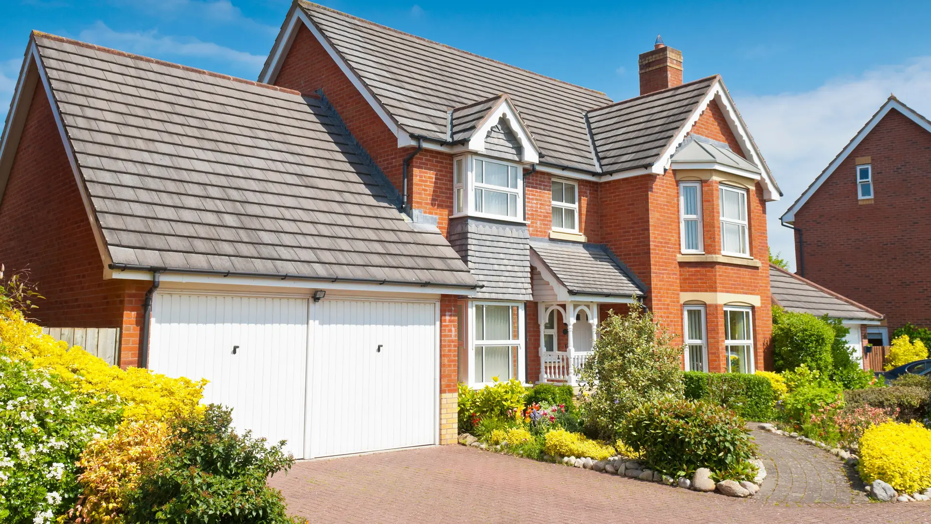 Detached brick house with a grey tiled roof